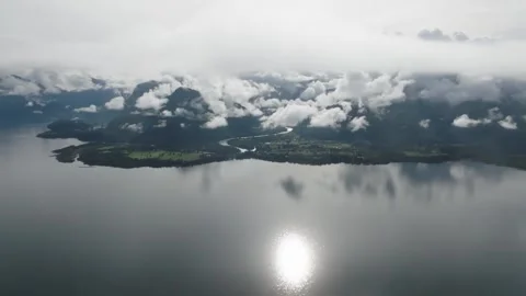Aerial view Mountain Reflections on Calm Water Under a Cloudy Sky Stock Footage 312751099