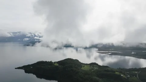 Aerial view Mountain Reflections on Calm Water Under a Cloudy Sky Stock Footage 312751678