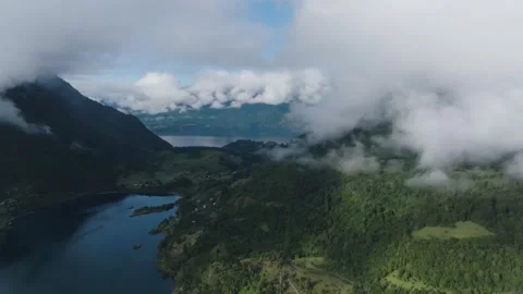 Aerial view Mountain Reflections on Calm Water Under a Cloudy Sky Stock Footage 312752470