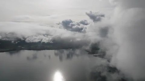 Aerial view Mountain Reflections on Calm Water Under a Cloudy Sky Stock Footage 312752488