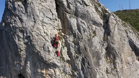 Aerial view of mountain rescuer doing rescue operations hanging on a rope Stock Footage 301045492