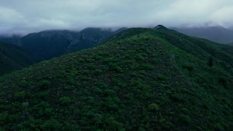 Aerial view of a mountain ridge and dam under low mist, Robertson Stock Footage 342335774
