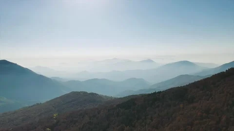 Aerial view of mountain ridge with range of mountains in the background Stock Footage 289577635