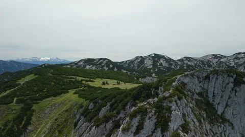 Aerial view of mountain ridge with summit cross and distant Dachstein glacier Stock Footage 342838304