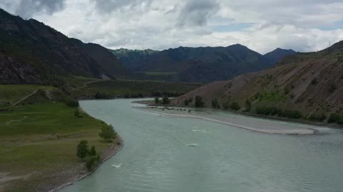 Aerial view of the mountain river between the mountains Stock Footage 317743375