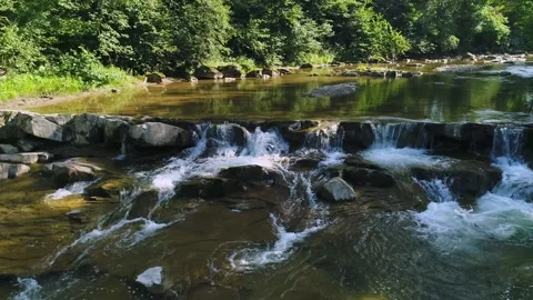 Aerial view. A mountain river with clear water flowing quickly over stone rapids Video stock 250477905
