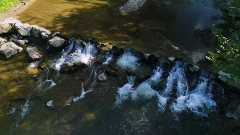 Aerial view. A mountain river with clear water flowing quickly over stone rapids Stock-Footage 250478742