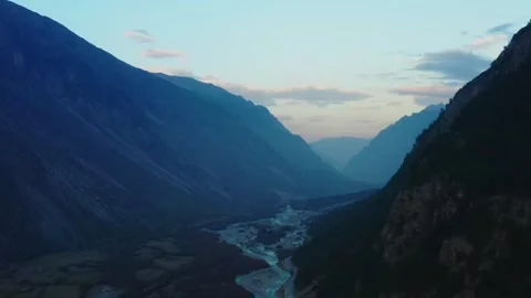 Aerial view of a mountain river in a deep valley at sunset in the North Caucasus Stock Footage 320855616