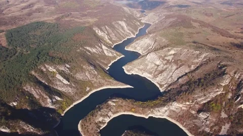 Aerial view on mountain river surrounded with autumn forest and mountains Stock Footage 68382665