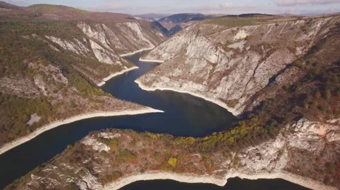 Aerial view on mountain river surrounded with autumn forest and mountains Stock Footage 68382729