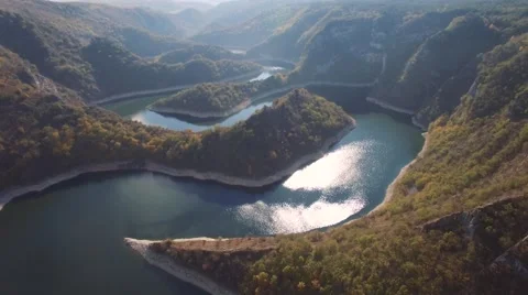 Aerial view on mountain river surrounded with autumn forest and mountains Stock Footage 68382782