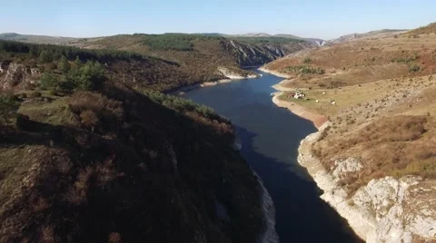 Aerial view on mountain river surrounded with autumn forest and mountains Stock Footage 68383029