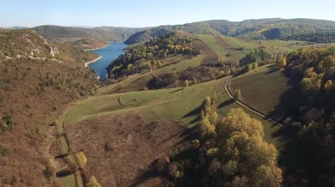 Aerial view on mountain river surrounded with autumn forest and mountains Stock Footage 68383543