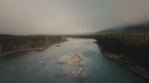 Aerial view of mountain river, valleys and forest through clouds in the morning Stock Footage 144201310