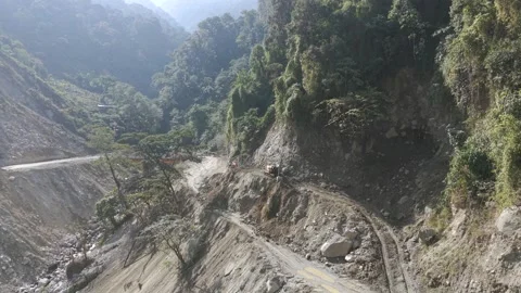 Aerial View of Mountain Road Construction and Landslide Clearing in India Stock Footage 332688912