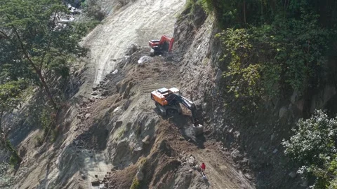 Aerial View of Mountain Road Construction and Landslide Clearing in India Stock Footage 332688923