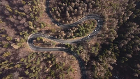 Aerial view of mountain road during springtime.Cars driving in the mountain road Stock Footage 151253553