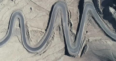Aerial view of the mountain road full of hairpin bends Stock Footage 147926537