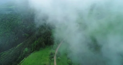 Aerial view of a mountain road going into fog. Stock Footage 157240279