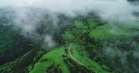 Aerial view of a mountain road going into fog Stock Footage 157240366