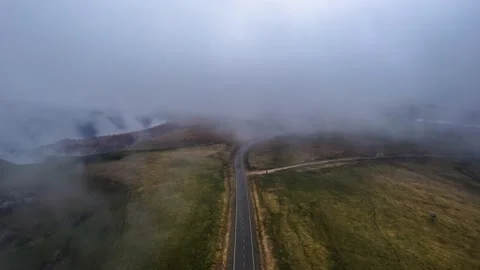 Aerial view of a mountain road going into the fog. Stock Footage 195563176