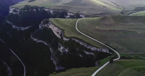 Aerial view of a mountain road passing through green fields. Stock Footage 158460927