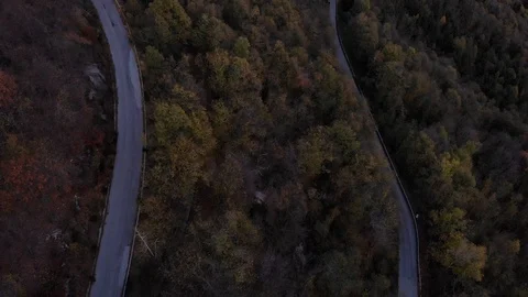 Aerial view of mountain road with switchbacks, in the autumn of evening Stock Footage 119851583