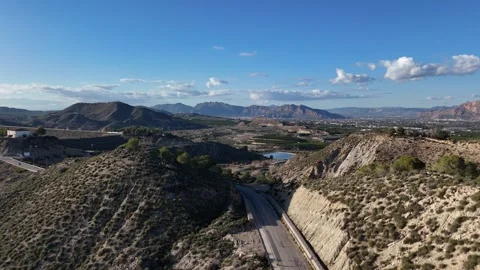 Aerial view of mountain road through dry hills in Spanish landscape Stock Footage 330748829