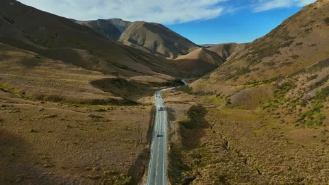 Aerial View of Mountain Road Through Desert Valley Stock Footage 341606891