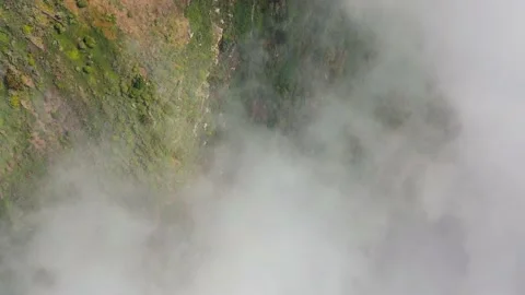 Aerial view of mountain slopes at cloud level covered with green vegetation Stock Footage 157313385