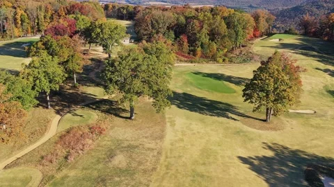 Aerial view of a mountain top golf course with a valley view in the background Stock Footage 219701706