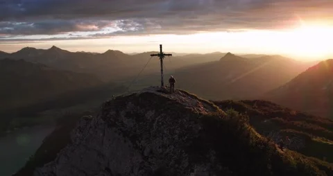 Aerial View of Mountain Top at Sunset in the Alps with Summit Cross Stock Footage 236499543