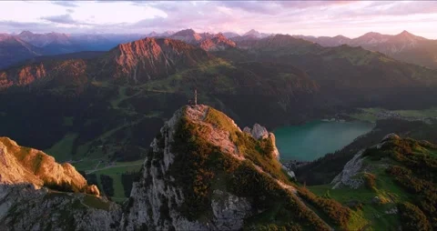 Aerial View of Mountain Top at Sunset in the Alps with Summit Cross Stock Footage 236499853