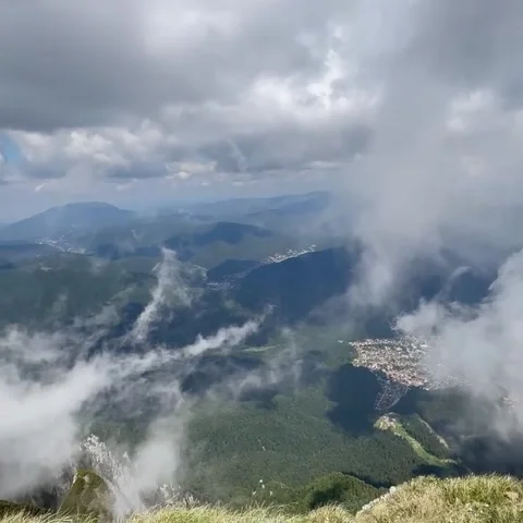 Aerial View of Mountain Town Through Clouds Stock Footage 341317012