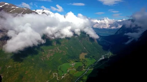 Aerial View of Mountain Valley with Clouds and Lush Greenery Stock Footage 308635374