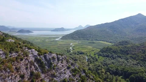 Aerial View of Mountain Valley with River Flowing into Skadar Lake Video stock 342772552
