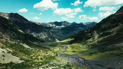 Aerial view of mountain valley stream under blue sky Stockbeeldmateriaal 344652033