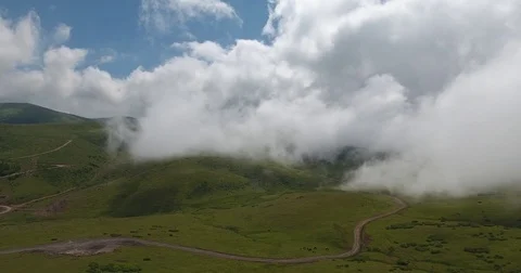 Aerial view of mountain village under clouds. 4k footage. Stock Footage