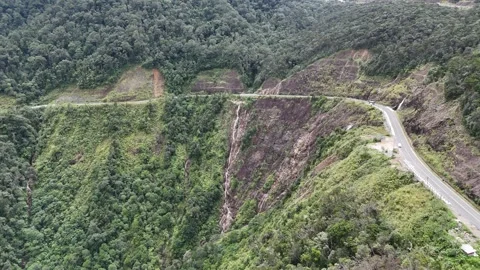 Aerial view of mountain waterfall and winding road at Khanh Le Pass 動画素材 337400655