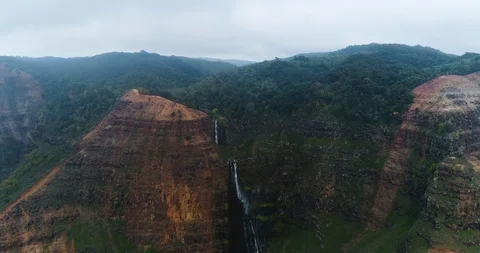Aerial view of a mountain with a waterfall on the side, hawaii Stock Footage 135264484