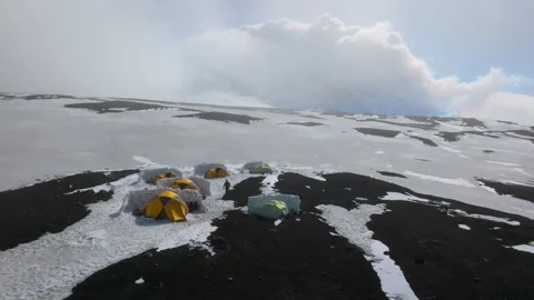 Aerial view of a mountaineering base camp on a snowy volcano 스톡 동영상 335498267