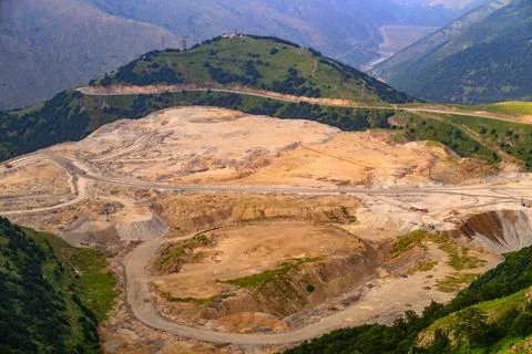 Aerial view of mountainous mining operation with exposed earth and winding .. Stock Photos