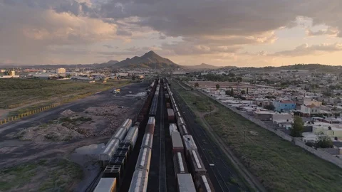 Aerial view of mountainous train yard at sunset in Northern Mexico (4K) Stock Footage 127763236