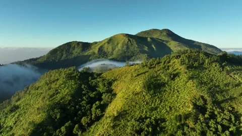 Aerial View of Mountains Above the Clouds at Sunrise Stock Footage 244754373