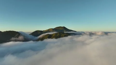 Aerial View of Mountains Above the Clouds at Sunrise Видео 244756014