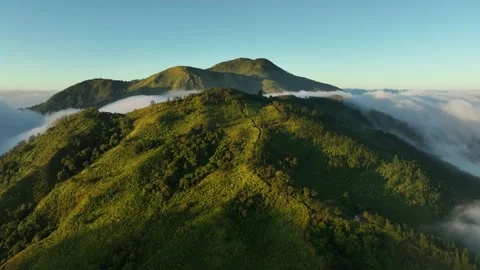 Aerial View of Mountains Above the Clouds at Sunrise Stock Footage 244756063