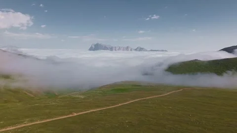Aerial view of mountains above clouds with parallax movement across landscape Stock Footage 341355501