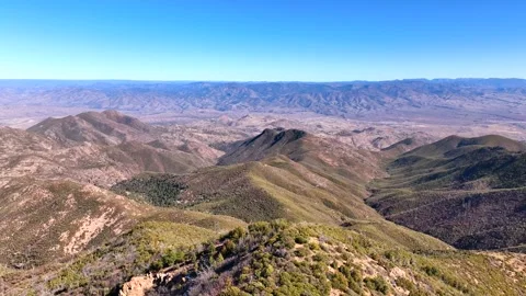 Aerial view of mountains and desert under clear sky, United States. Stock Footage 312760180