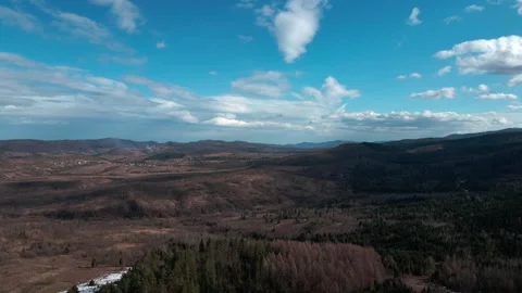 Aerial view of mountains and forest under dynamic sky Stock Footage 314745166