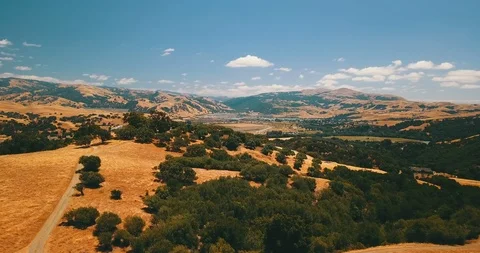 Aerial view of mountains with brown grass field Stock Footage 117314701